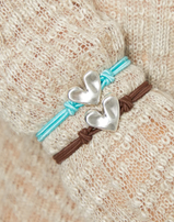 Bracciale UNOde50 in filo elastico marrone con cuore placcato argento sterling Ref. PUL2641